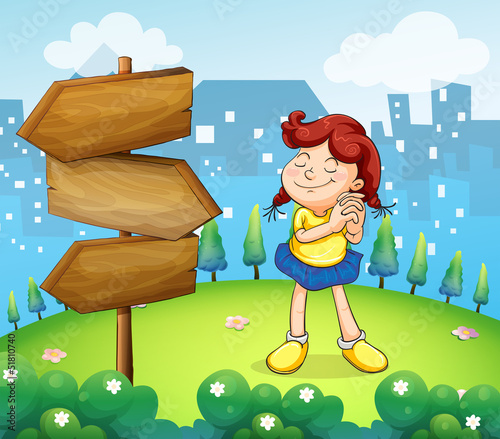 A little girl standing beside the wooden arrow boards