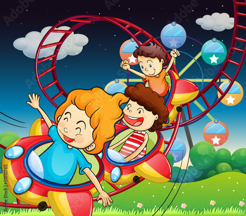 Three kids riding in a roller coaster