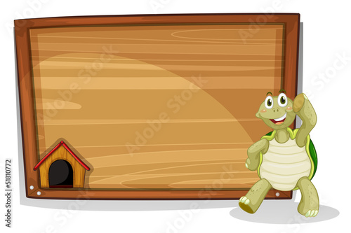 A turtle beside a wooden empty board
