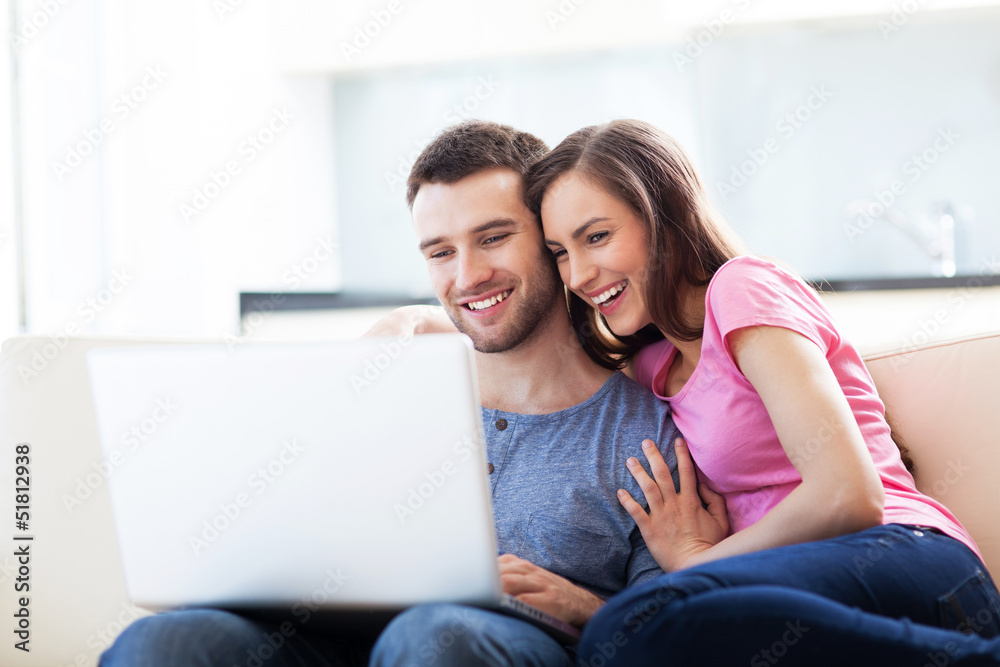 Couple on sofa with laptop