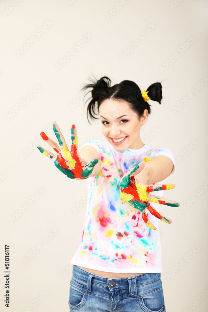 Young pretty painter with hands in paint, on gray background Young pretty painter with hands in paint, on gray background