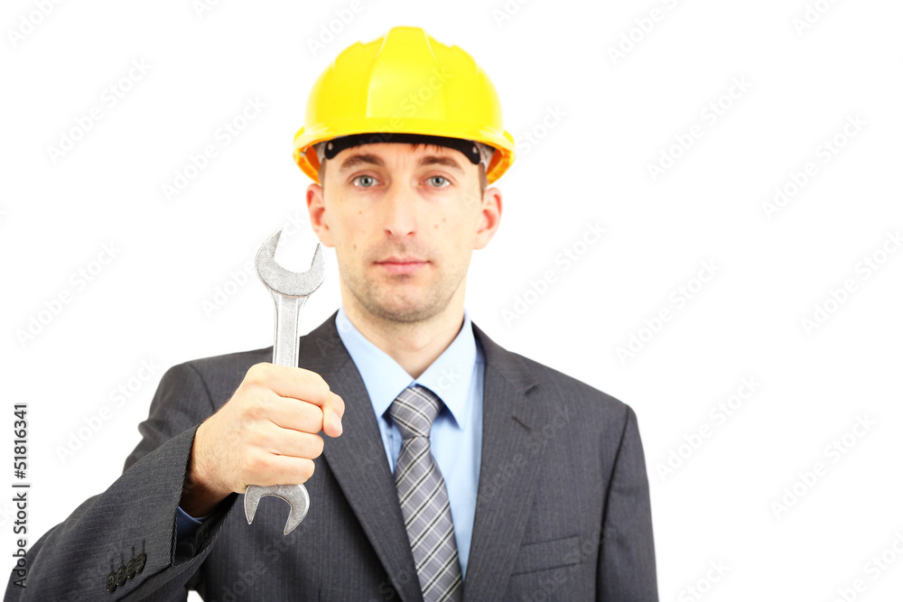 Young businessman in helmet with wrench isolated on white. Young businessman in helmet with wrench isolated on white.
