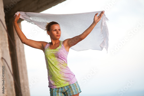 Blond woman with white shawl relaxing near the sea photo