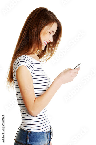Young smiling caucasian tenn using cell phone