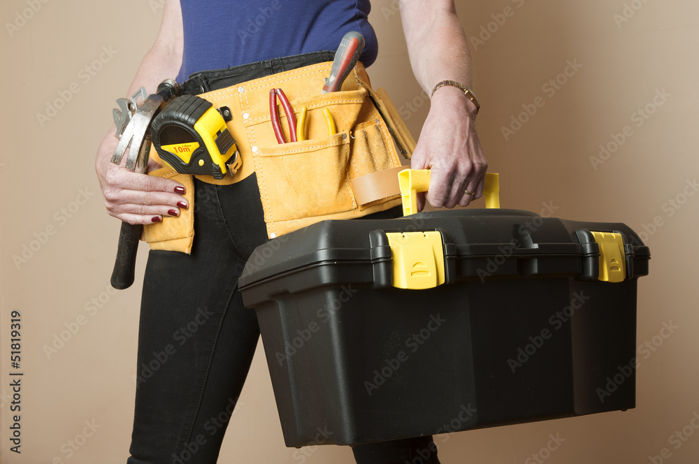 Female worker wearing a toolbelt work apron Female worker wearing a toolbelt work apron