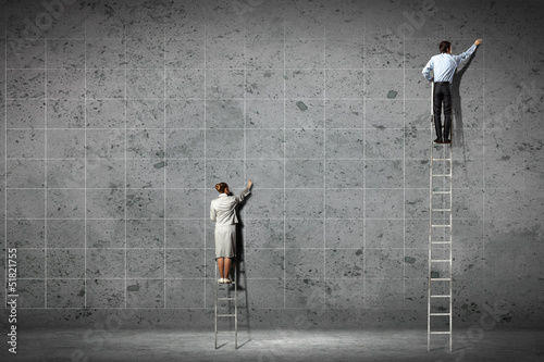 businesspeople drawing diagrams on wall photo