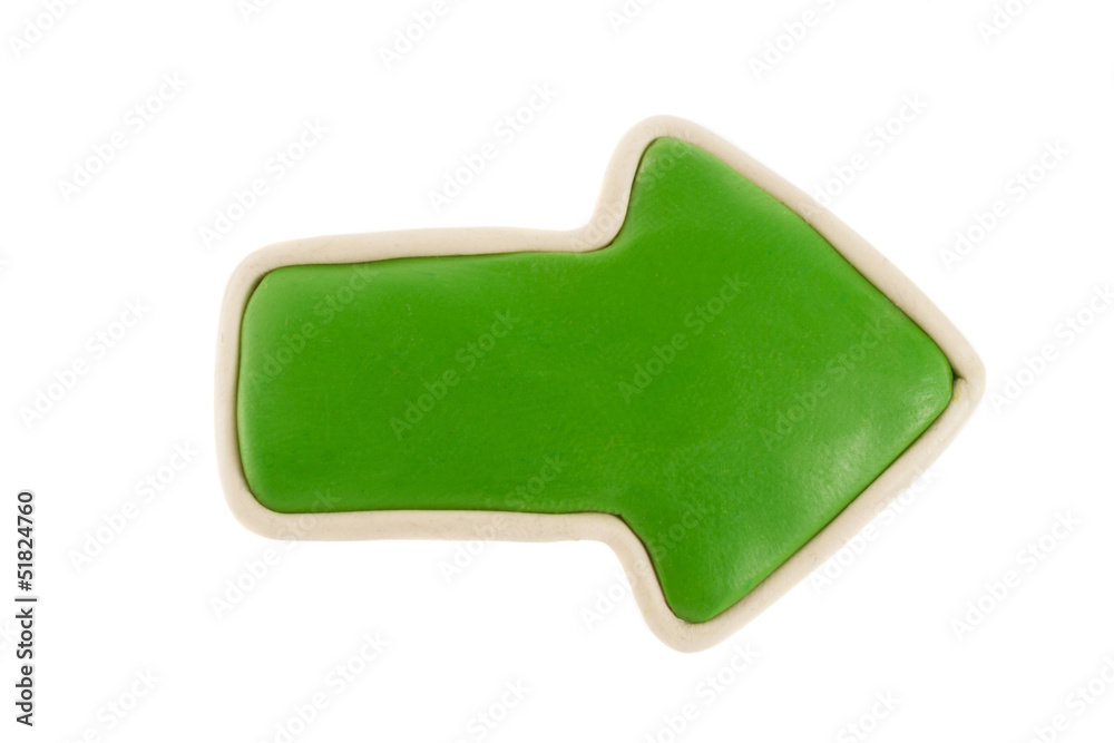 Green arrow from plasticine on a white background Green arrow from plasticine on a white background