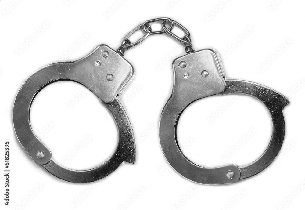 Old steel handcuffs on a white background. Old steel handcuffs on a white background.