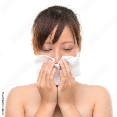 Flu or cold - sneezing woman sick blowing nose.