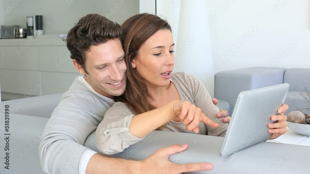 Couple websurfing on internet with tablet Couple websurfing on internet with tablet