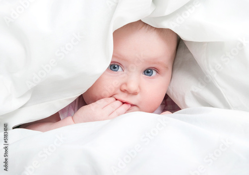 cute baby under a blanket