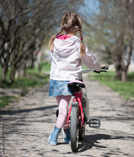 Fototapeta Naklejka Na Ścianę i Meble -  little girl on her bike
