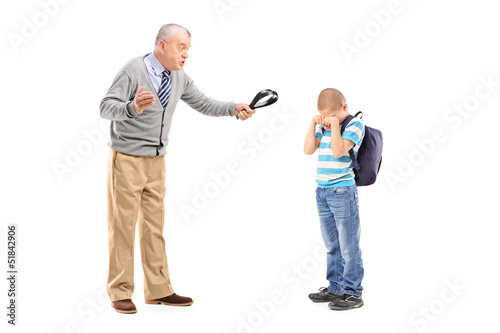 Tablou pe pânză Angry grandfather holding a belt and threatening on his nephew