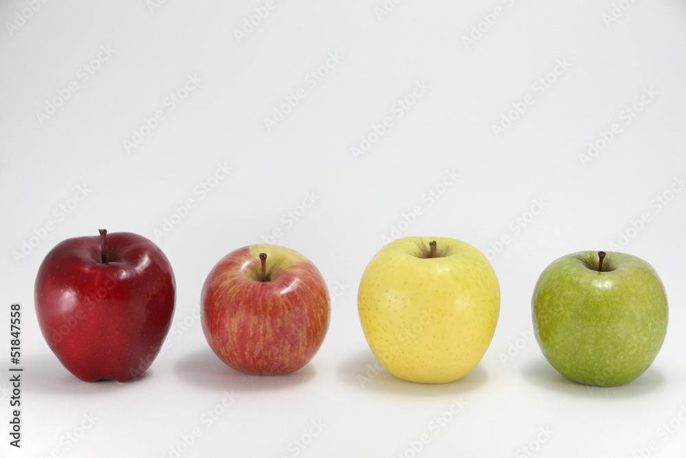 Four apples of different color against white background Four apples of different color against white background