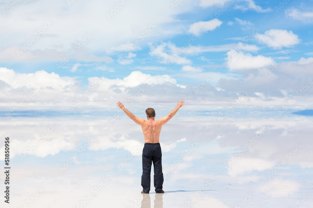 Rear view of a man worshiping in nature Rear view of a man worshiping in nature