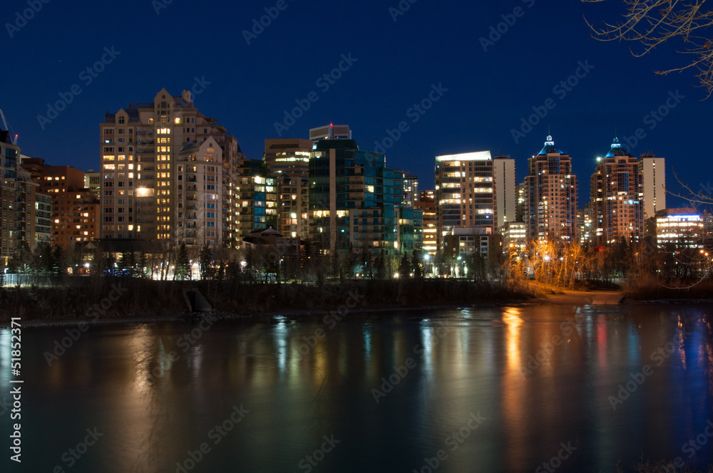 Luxury condos at night along the Bow River in Calgary Alberta