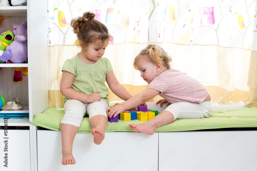 children sisters play together indoors children sisters play together indoors