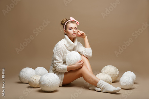 Housework. Woman in White Tricot with Woolen Balls. Seamstress