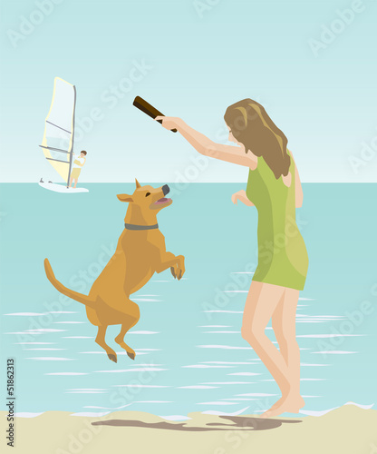 girl playing with a dog by the sea