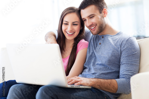 Couple on sofa with laptop