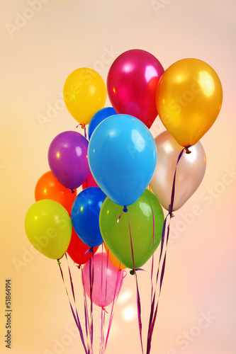 Many bright balloons on orange background