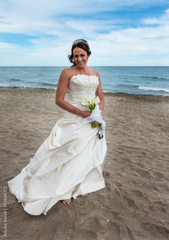 Bride alone on the beach next to the Mediterranean Sea Bride alone on the beach next to the Mediterranean Sea