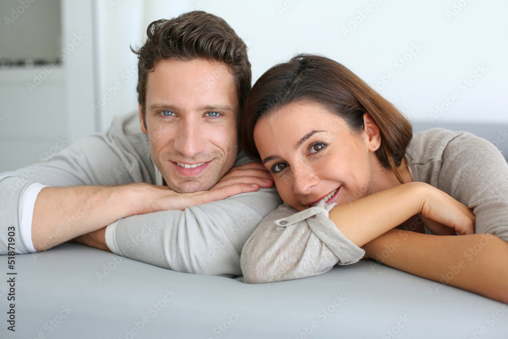 Portrait of sweet couple sitting in sofa Portrait of sweet couple sitting in sofa