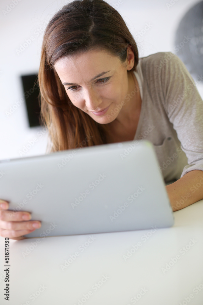 Young cheerful woman using electronic tablet Young cheerful woman using electronic tablet