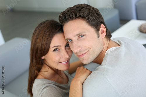 Upper view of sweet couple sitting in sofa