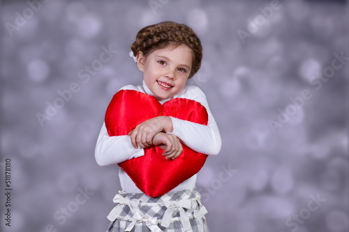 Photography Girl tenderly embraces plush heart