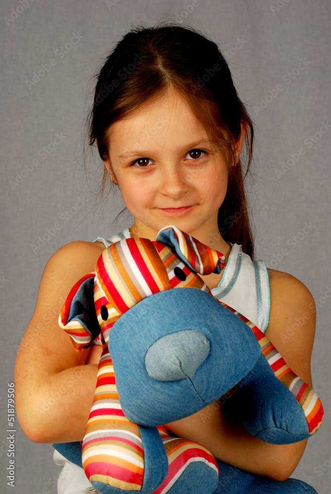 Little girl with a toy dog