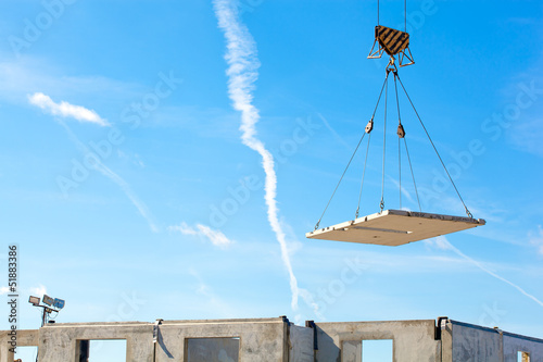 Hoisting works by means of tower crane photo
