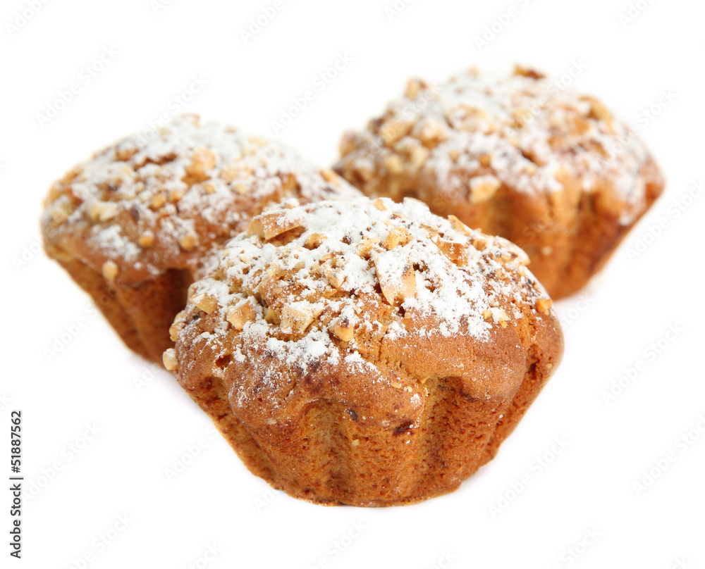 Tasty muffin cakes with powdered sugar, isolated on white Tasty muffin cakes with powdered sugar, isolated on white