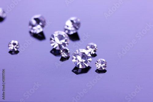 Beautiful shining crystals (diamonds), on purple background