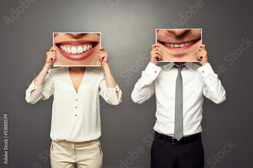 man holding pictures with big smile