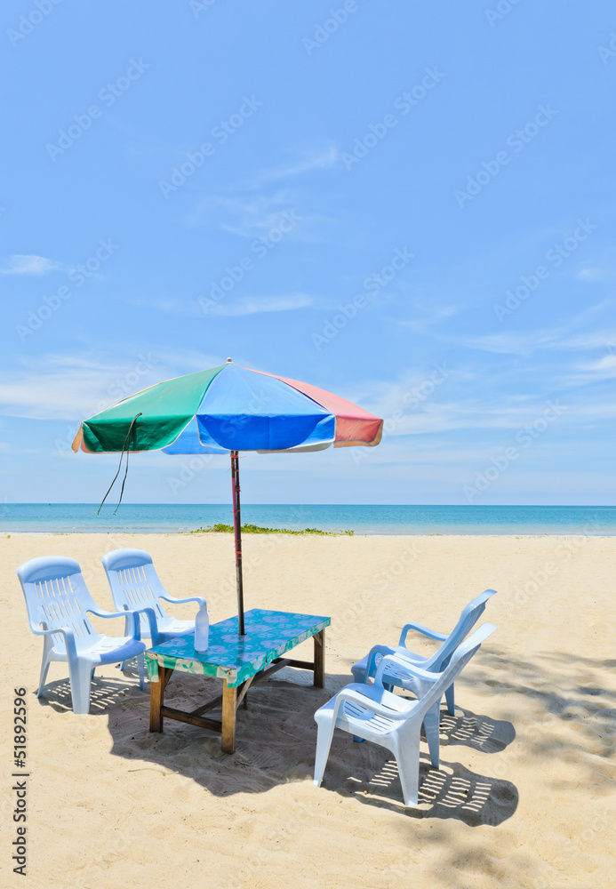 Sun shade with chairs at tropical beach