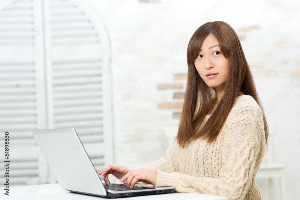 Beautiful asian woman using a laptop computer Beautiful asian woman using a laptop computer