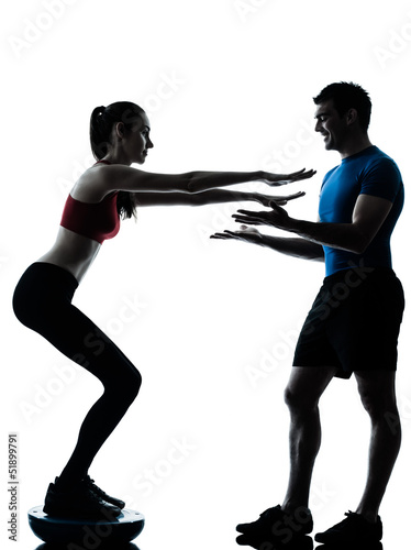 coach man woman exercising squats on bosu