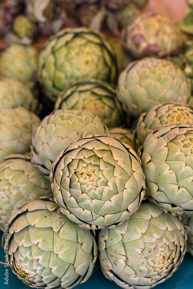 Fototapeta premium Pile of Artichoke on display at market