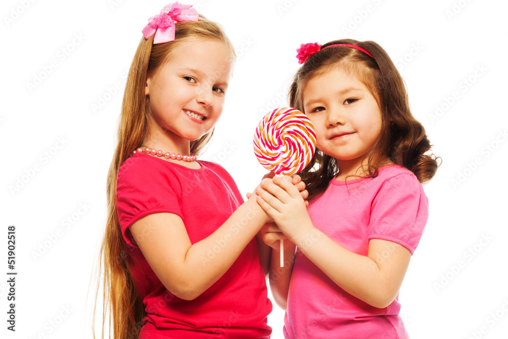 Two girls with lollipop