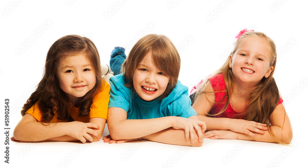 Three kids laying in line Three kids laying in line