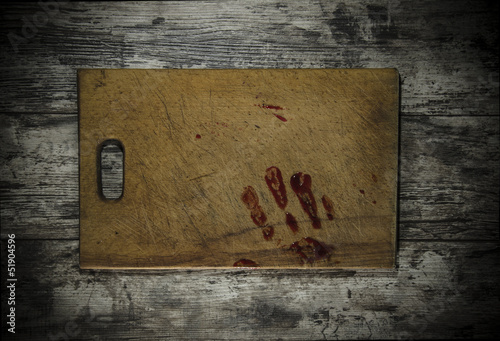 Grunge wooden background with a print of a bloody hand