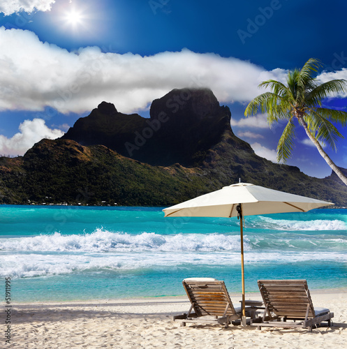 View of the mountain ,beach chairs and sea.