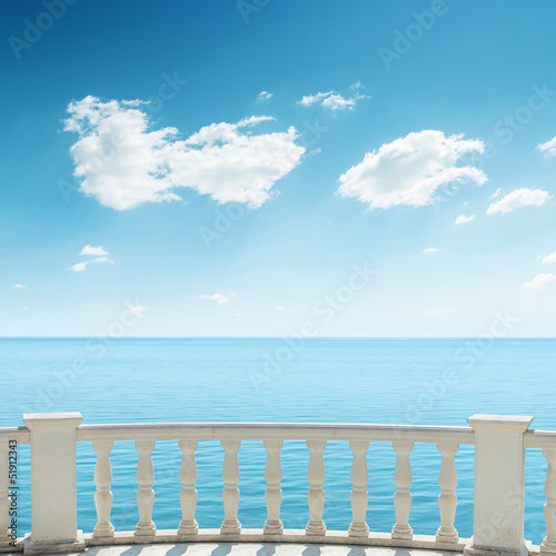 view to the sea from a balcony under cloudy sky