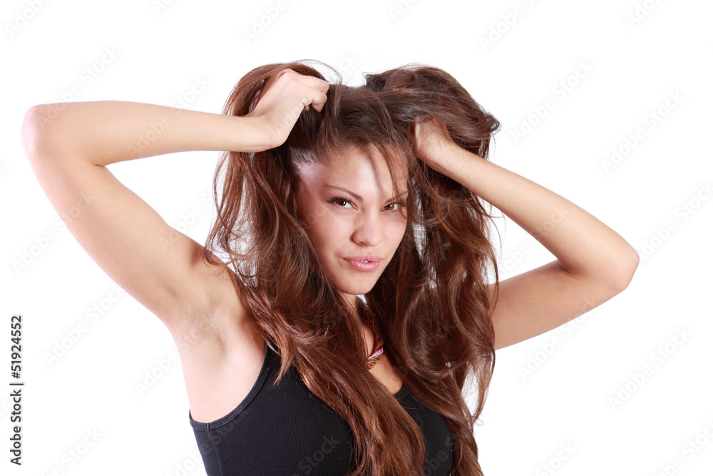 Young brunette woman tears her hair and looks at camera Young brunette woman tears her hair and looks at camera