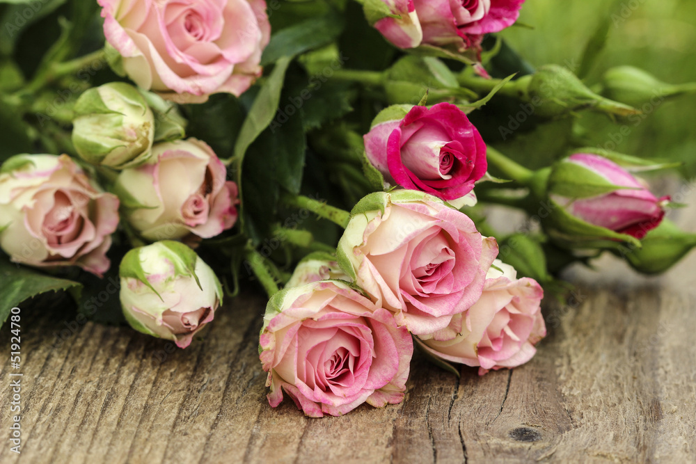 Fabulous bouquet of colorful roses on wooden tray in fresh sprin Fabulous bouquet of colorful roses on wooden tray in fresh sprin