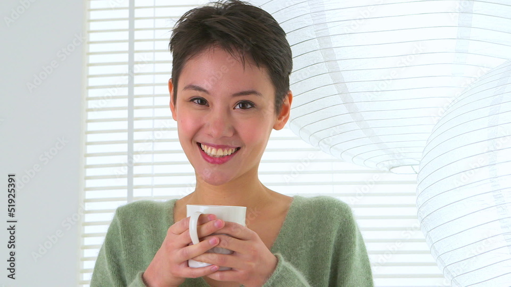 Happy Asian woman drinking tea Happy Asian woman drinking tea