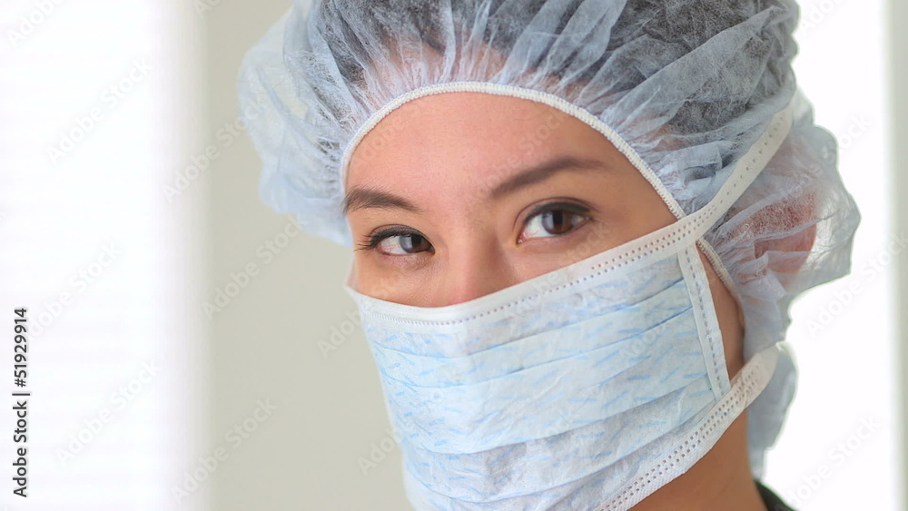 Close up of Chinese woman doctor wearing surgical mask Close up of Chinese woman doctor wearing surgical mask