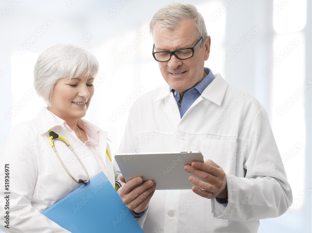 Smiling Doctor and Nurse with Digital Tablet Smiling Doctor and Nurse with Digital Tablet