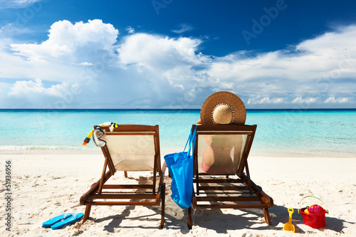 Woman on a tropical beach in chaise lounge